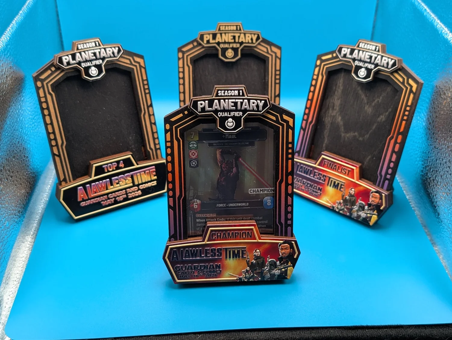 A set of engraved wooden prize-card frames staged for a tournament.