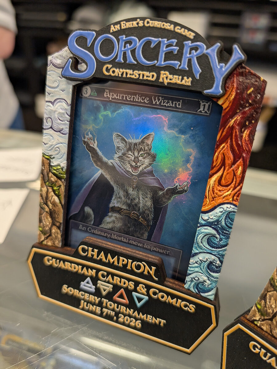 A carved and painted Sorcery: Contested Realm champion prize frame holding a winner's card.